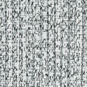 Woven fabric sample, white and gray tweed, dense irregular nubby texture with speckled pattern and visible “turri” label.